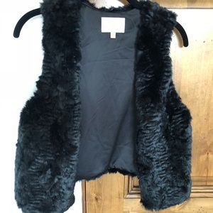 Skies are blue black cropped fur vest